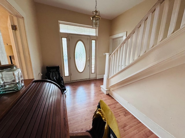 entryway with hardwood / wood-style flooring