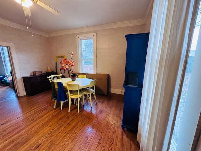 dining space featuring wood-type flooring, ceiling fan, and crown molding