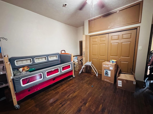 miscellaneous room featuring ceiling fan and dark wood-type flooring