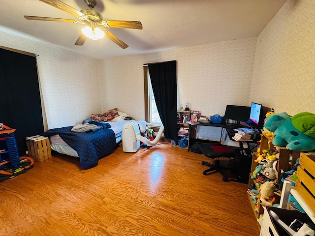 bedroom with ceiling fan and hardwood / wood-style floors