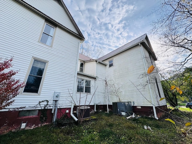 view of side of home featuring cooling unit