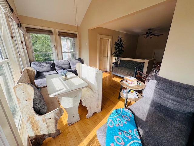 dining space featuring ceiling fan, vaulted ceiling, and light hardwood / wood-style flooring