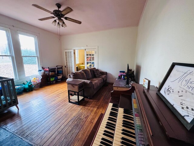 living room featuring wood-type flooring, french doors, and ceiling fan