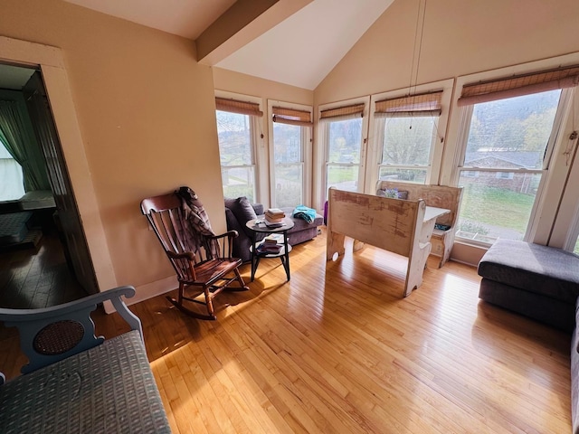 sunroom / solarium featuring vaulted ceiling and a wealth of natural light