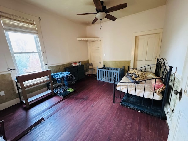 bedroom featuring ceiling fan and dark hardwood / wood-style flooring