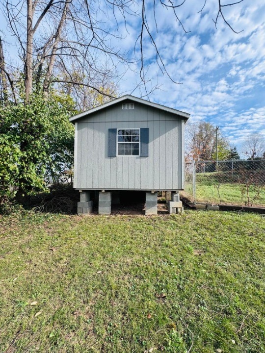 view of outbuilding featuring a lawn