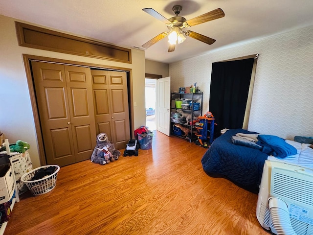 bedroom featuring ceiling fan, a closet, and wood-type flooring