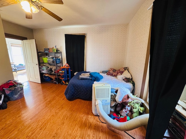 bedroom with wood-type flooring and ceiling fan