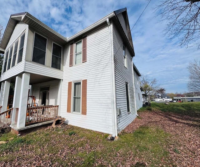 rear view of property with covered porch