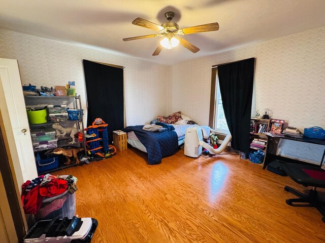 bedroom featuring wood-type flooring and ceiling fan