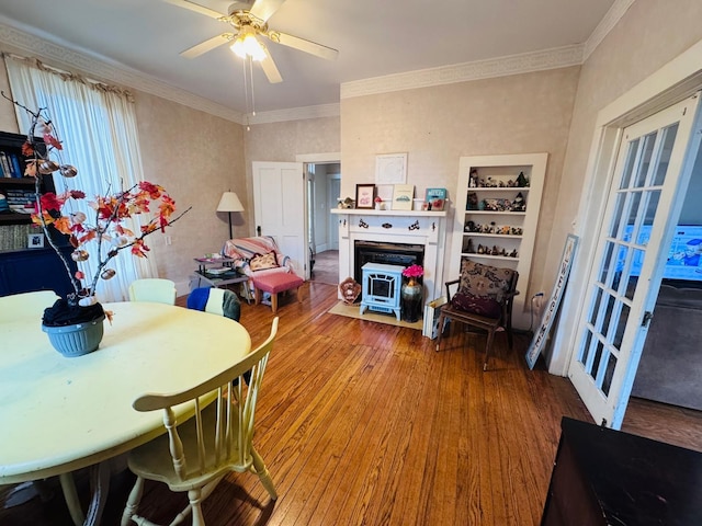 dining room featuring hardwood / wood-style flooring, ceiling fan, and crown molding