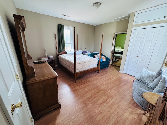 bedroom with a closet and light hardwood / wood-style floors