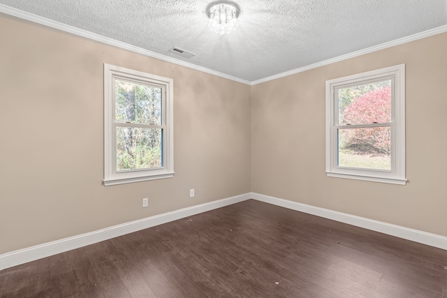 empty room featuring a textured ceiling, ornamental molding, and dark wood-type flooring