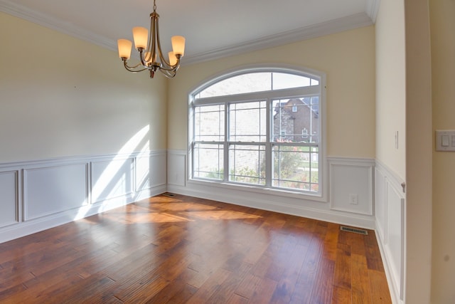 unfurnished room featuring plenty of natural light, a chandelier, dark hardwood / wood-style floors, and ornamental molding