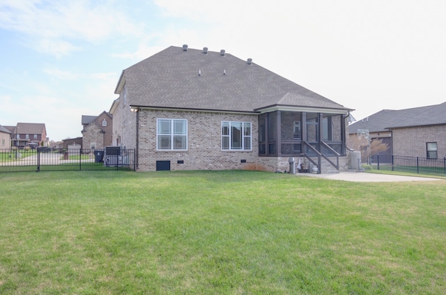 back of property featuring a lawn and a sunroom