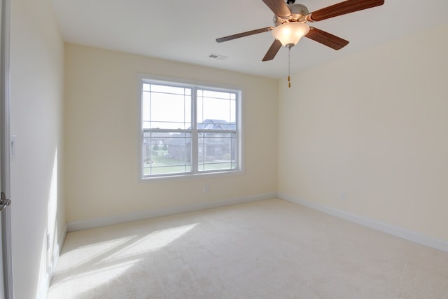 empty room featuring light carpet and ceiling fan