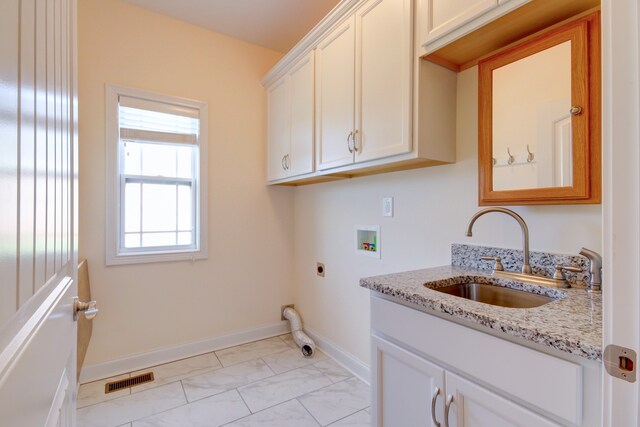 clothes washing area with cabinets, sink, washer hookup, and hookup for an electric dryer