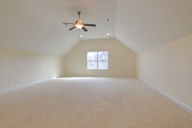 additional living space featuring light colored carpet, vaulted ceiling, and ceiling fan