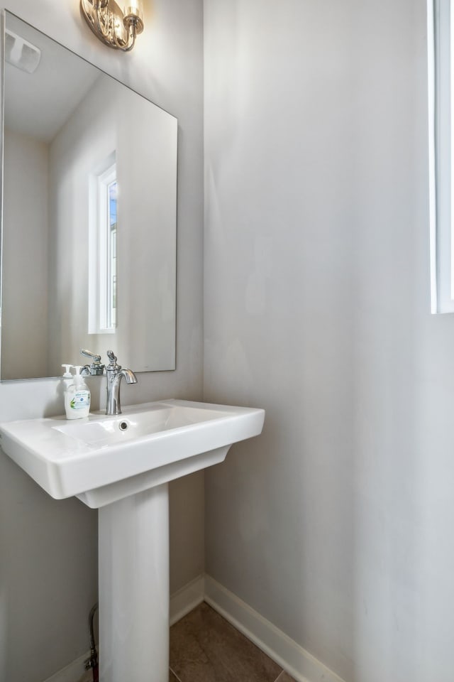 bathroom with tile patterned flooring, plenty of natural light, and sink