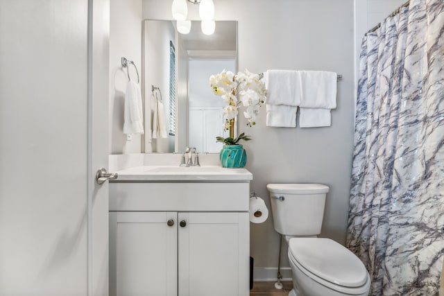 bathroom featuring vanity, a shower with shower curtain, and toilet