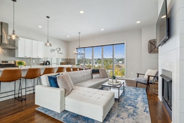 living room with dark hardwood / wood-style floors and a notable chandelier