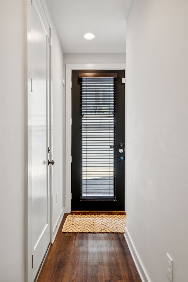 doorway with dark wood-type flooring