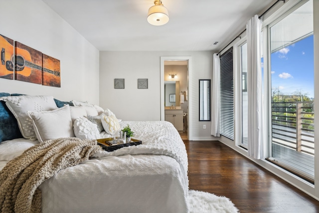 bedroom featuring connected bathroom, multiple windows, dark hardwood / wood-style flooring, and access to outside