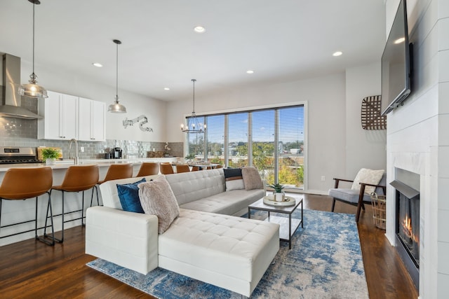 living room with dark hardwood / wood-style flooring and a chandelier