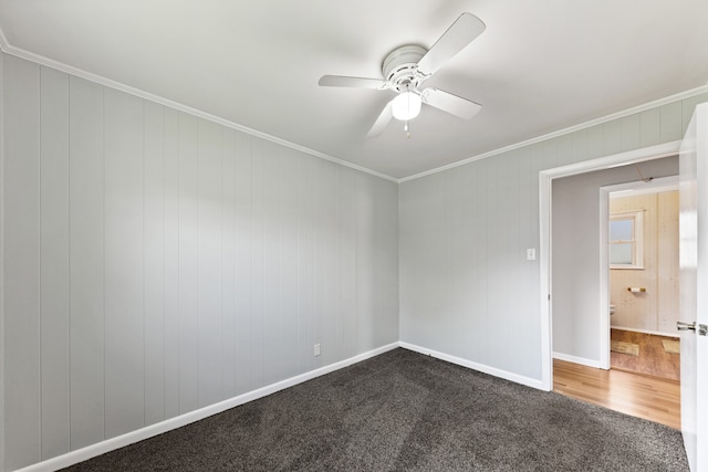 unfurnished room featuring ceiling fan, dark carpet, and ornamental molding