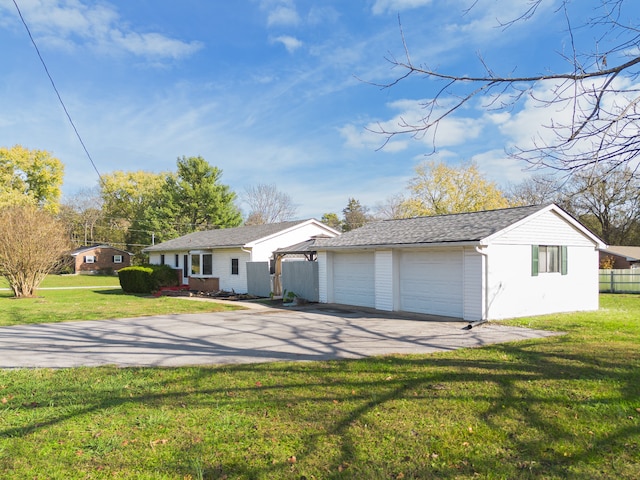 ranch-style home featuring a front yard and a garage