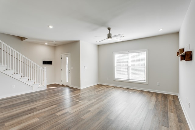 unfurnished living room featuring ceiling fan and hardwood / wood-style floors