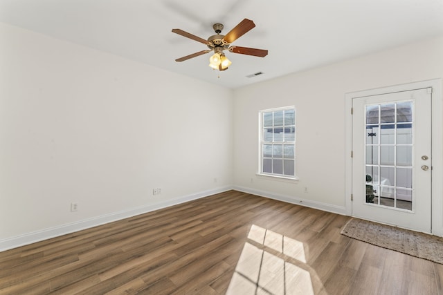 spare room featuring hardwood / wood-style floors and ceiling fan