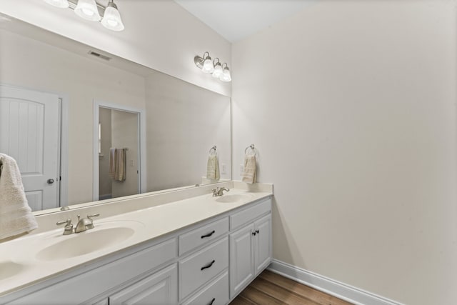 bathroom with hardwood / wood-style floors and vanity