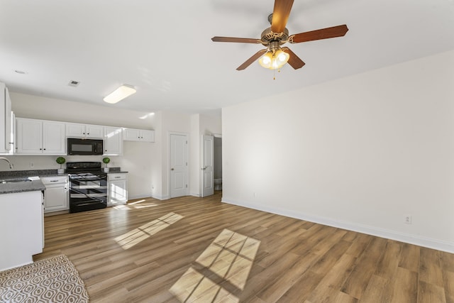 kitchen with ceiling fan, sink, black appliances, light hardwood / wood-style floors, and white cabinetry