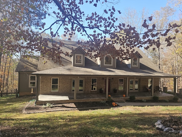 back of property featuring a patio and a lawn