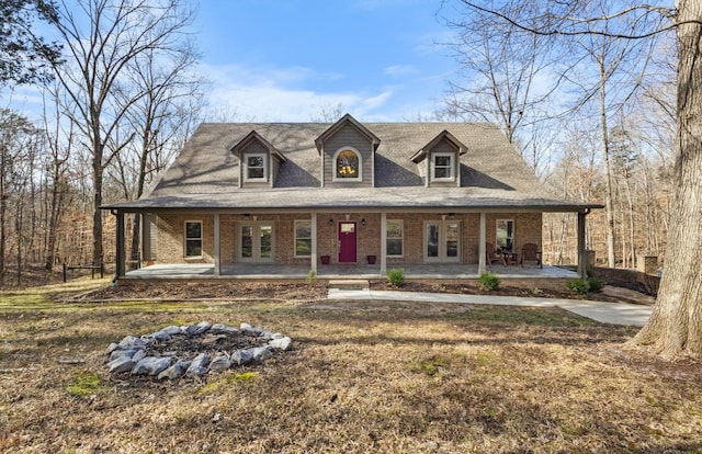 view of front of house featuring french doors, a patio area, a fire pit, and a front yard