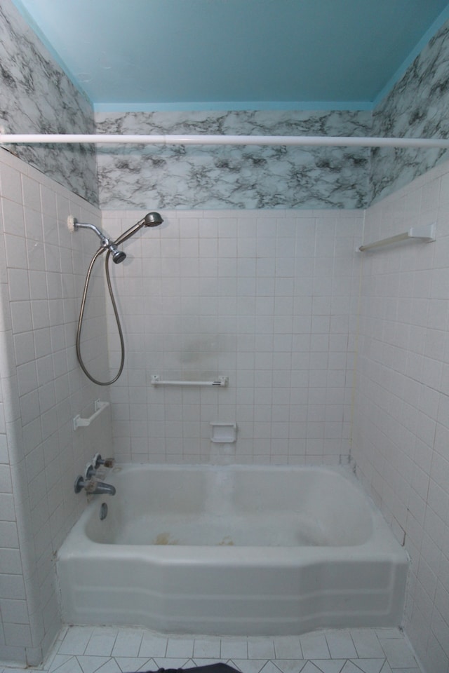 bathroom with tile patterned floors and tiled shower / bath