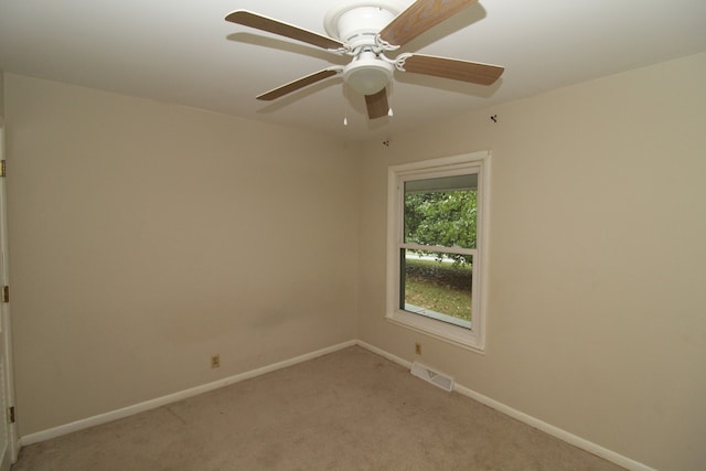 spare room featuring carpet flooring and ceiling fan