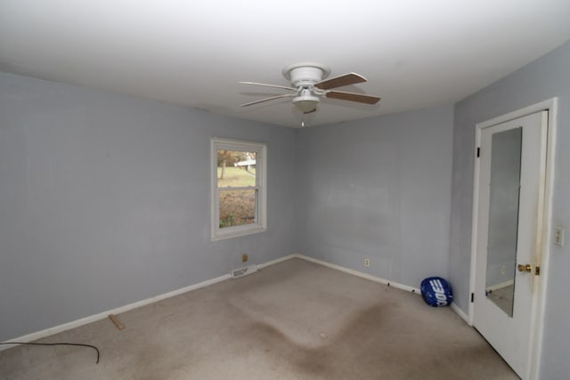 unfurnished room featuring light carpet and ceiling fan