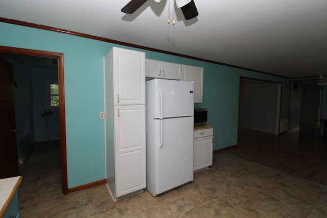 kitchen featuring ceiling fan, light hardwood / wood-style flooring, white fridge, white cabinets, and ornamental molding