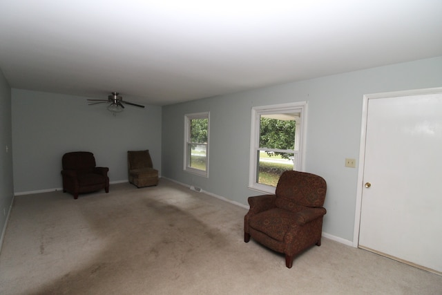 sitting room featuring light carpet and ceiling fan