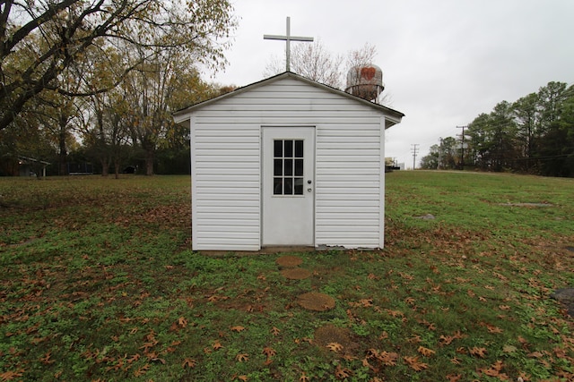 view of outbuilding featuring a yard