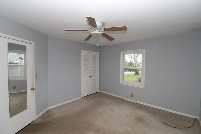 spare room with light colored carpet and ceiling fan