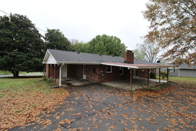 rear view of house featuring a carport