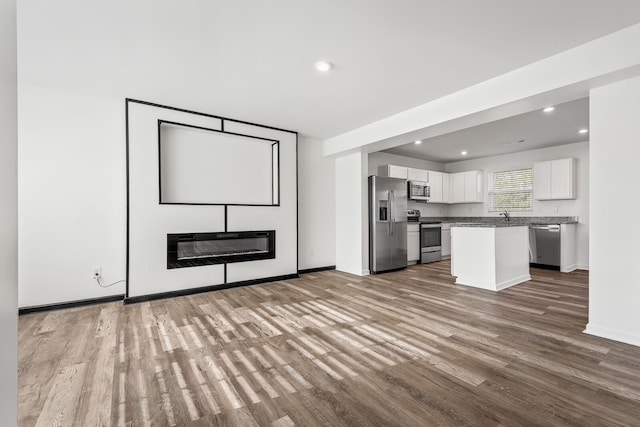 unfurnished living room with light hardwood / wood-style flooring