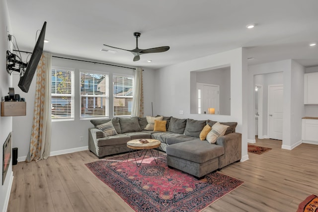 living room with ceiling fan and light wood-type flooring