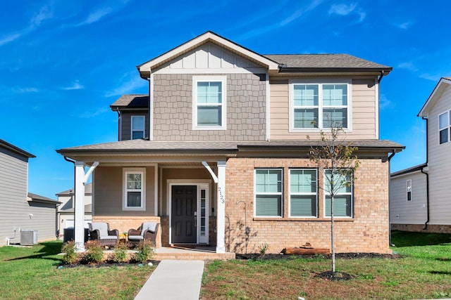 view of front facade featuring outdoor lounge area, a front lawn, and central air condition unit