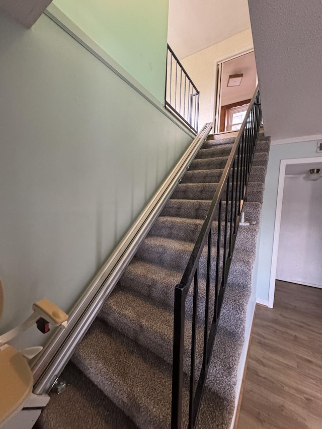 stairway featuring hardwood / wood-style floors