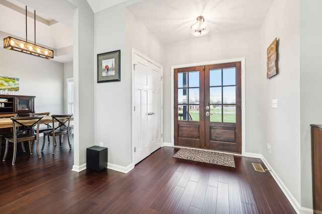 entrance foyer featuring dark hardwood / wood-style flooring and french doors