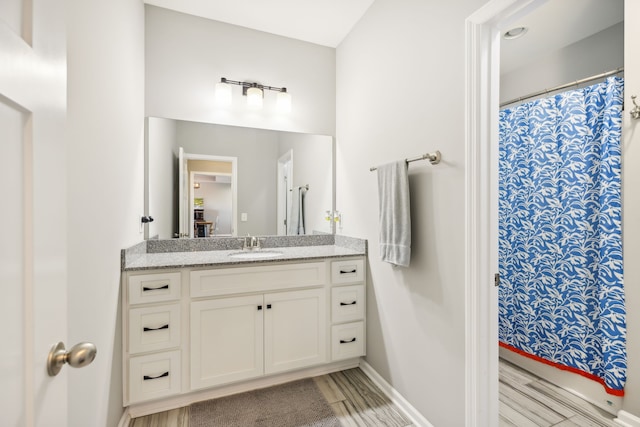 bathroom with hardwood / wood-style floors, vanity, and a shower with curtain